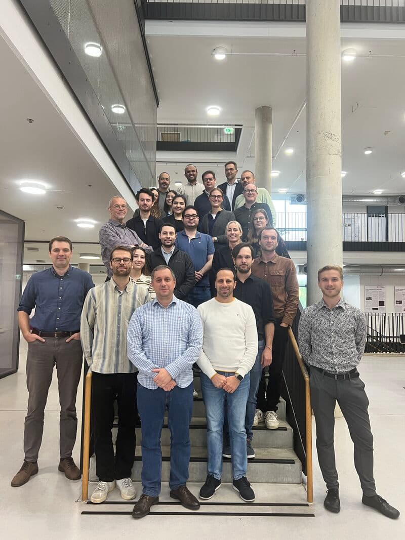 Project team on a staircase in a research building