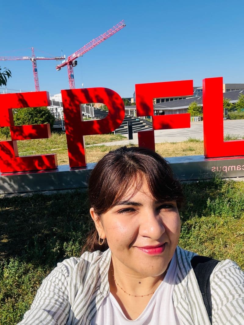 Zahra Tajalli in front of the EPFL campus sign in Lausanne